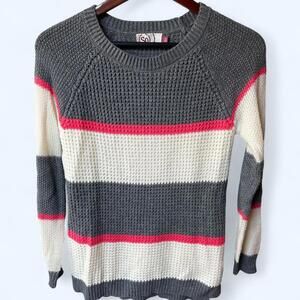So- Sweater featuring grey, cream and pink stripes with a cozy vibe.